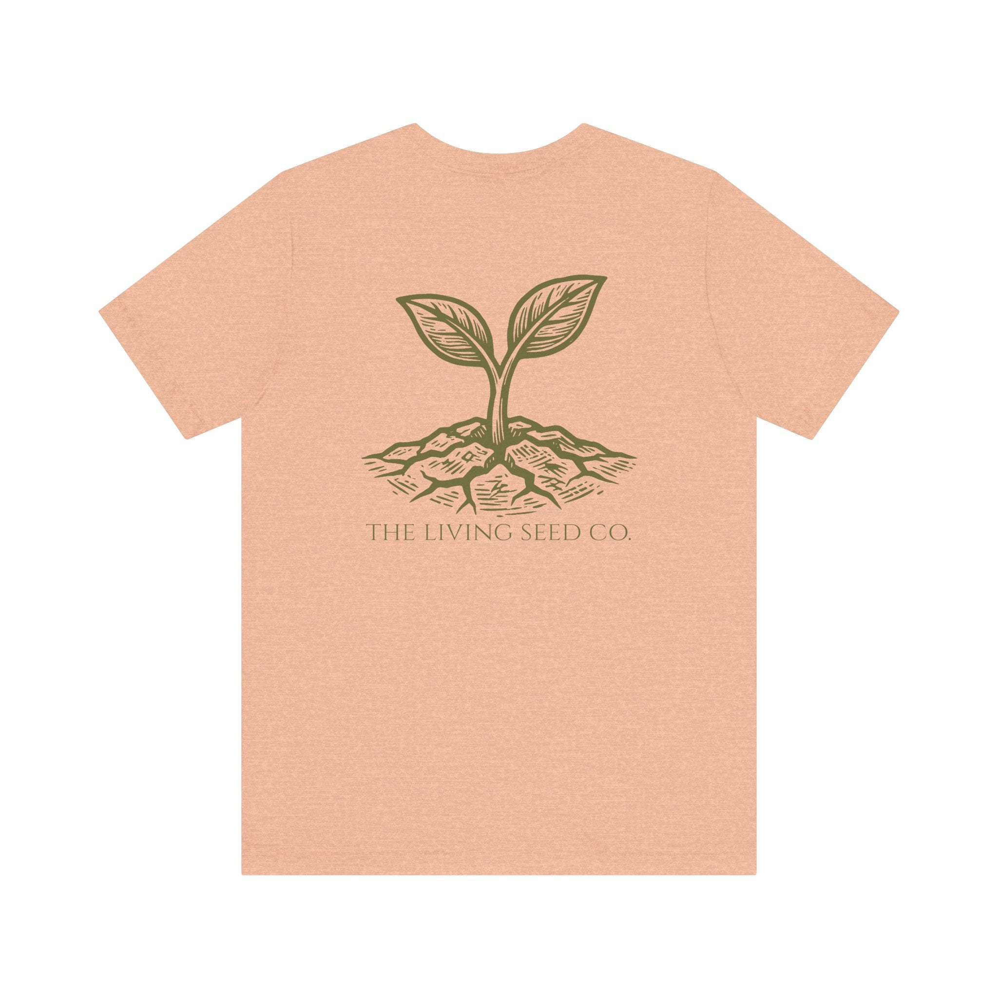 The Original Tee in Heather Peach — back view flat mockup — peach heather unisex t-shirt featuring The Living Seed Co. etching-style sprouting seed graphic in olive ink with wordmark below. Bella+Canvas 3001.