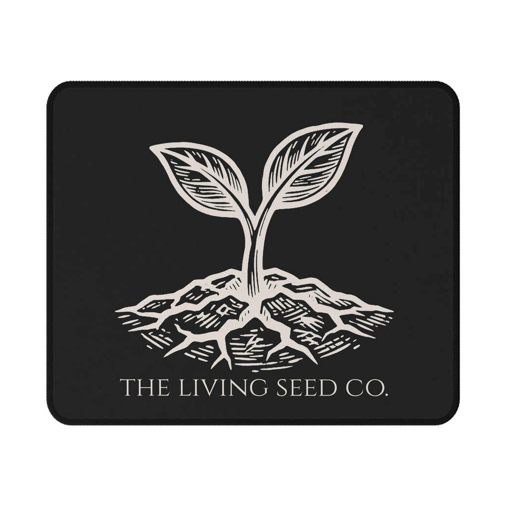 he Original Mouse Pad in Black — flat mockup — forest green mouse pad featuring The Living Seed Co. etching-style sprouting seed graphic in parchment ink with wordmark below