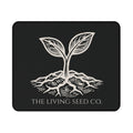 he Original Mouse Pad in Black — flat mockup — forest green mouse pad featuring The Living Seed Co. etching-style sprouting seed graphic in parchment ink with wordmark below