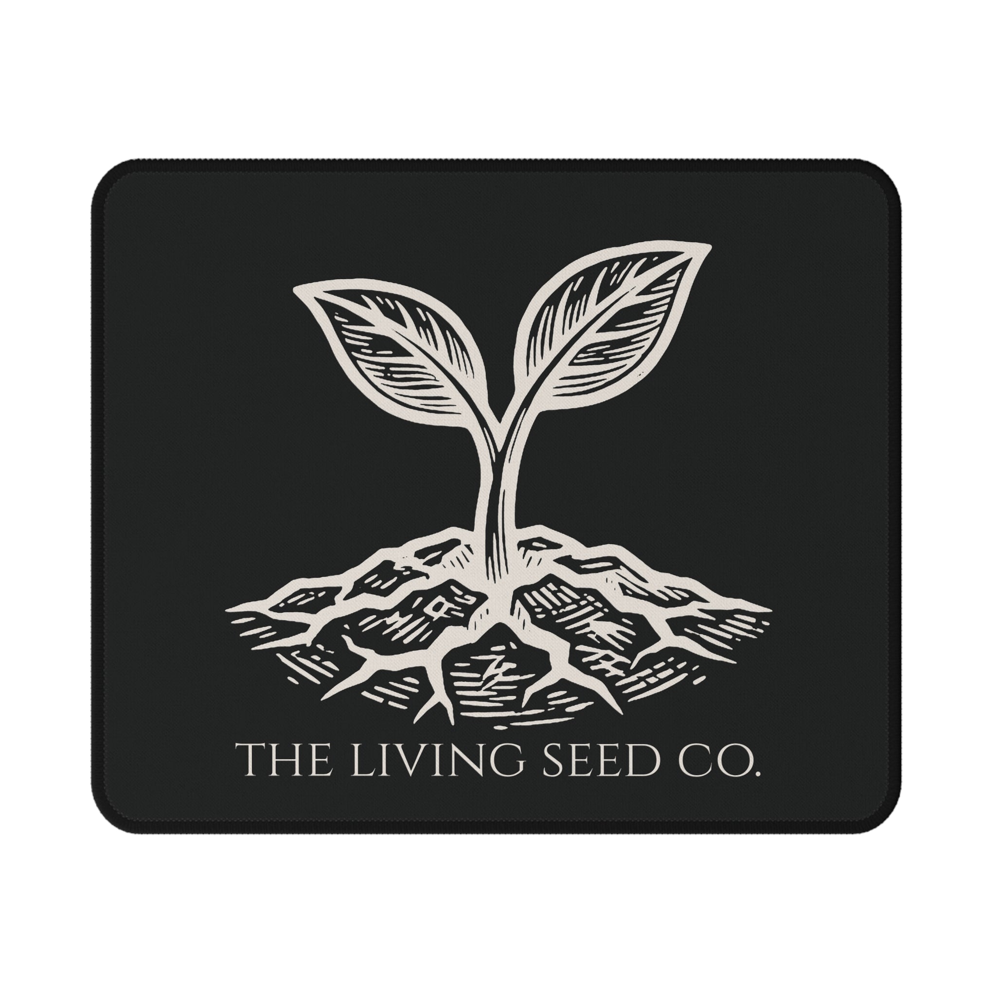 he Original Mouse Pad in Black — flat mockup — forest green mouse pad featuring The Living Seed Co. etching-style sprouting seed graphic in parchment ink with wordmark below