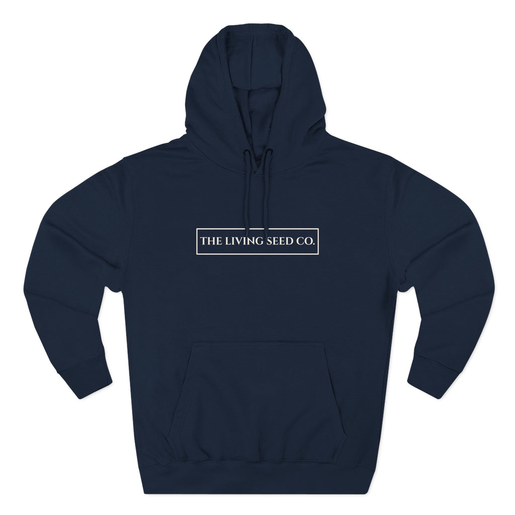 The Original Hoodie (Lane Seven) in Navy — front view flat mockup — navy pullover hoodie featuring The Living Seed Co. boxed wordmark on chest in parchment ink. Lane Seven LS14001.