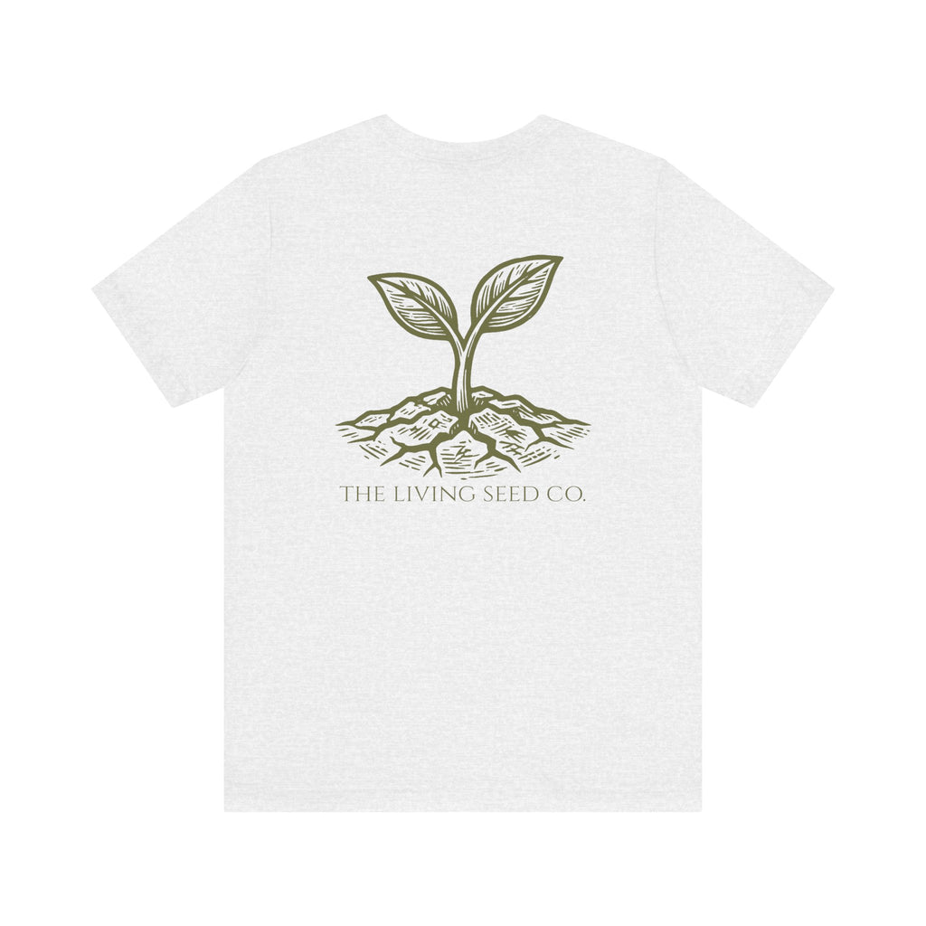 The Original Tee in Ash — back view flat mockup — ash heather unisex t-shirt featuring The Living Seed Co. etching-style sprouting seed graphic in olive ink with wordmark below. Bella+Canvas 3001.