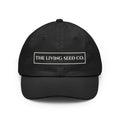 The Original Dad Hat in Black featuring The Living Seed Co. embroidered boxed wordmark on a relaxed unstructured bio-washed cotton dad hat
