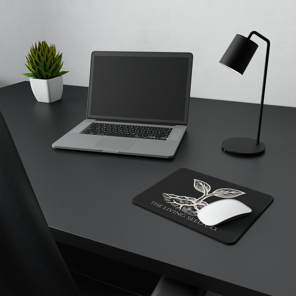 he Original Mouse Pad in Black — lifestyle shot — mouse pad on a dark desk alongside a laptop and lamp showing the Forest Deep colorway in a workspace setting.