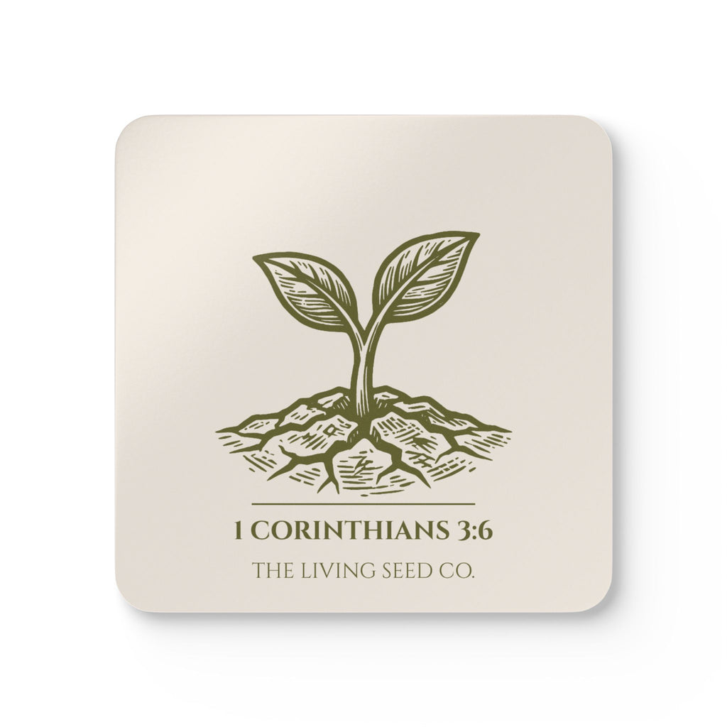 Parchment coaster with etching-style sprouting seed graphic, 1 Corinthians 3:6, and The Living Seed Co. wordmark on high-gloss MDF with cork back