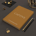 Scripture Series CAPTIVE Journal in Harvest Gold — hardcover journal featuring CAPTIVE in parchment lettering with 2 Corinthians 10:5 reference, styled on a desk with gold stationery accessories.