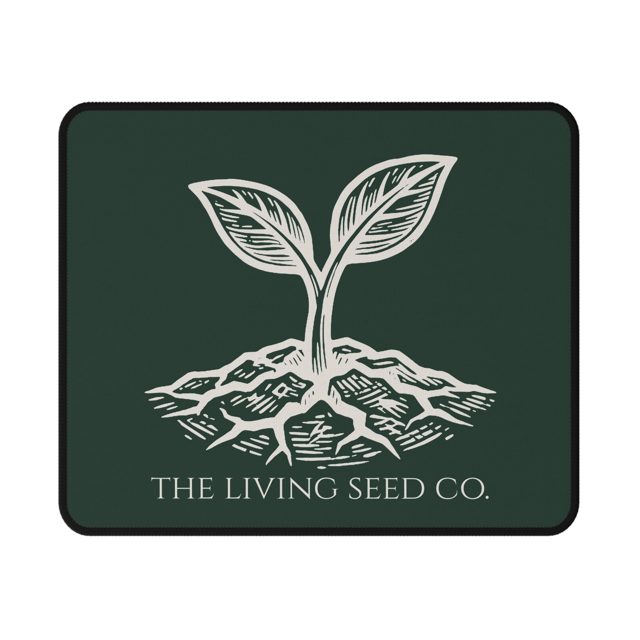The Original Mouse Pad in Forest Deep — flat mockup — forest green mouse pad featuring The Living Seed Co. etching-style sprouting seed graphic in parchment ink with wordmark below.