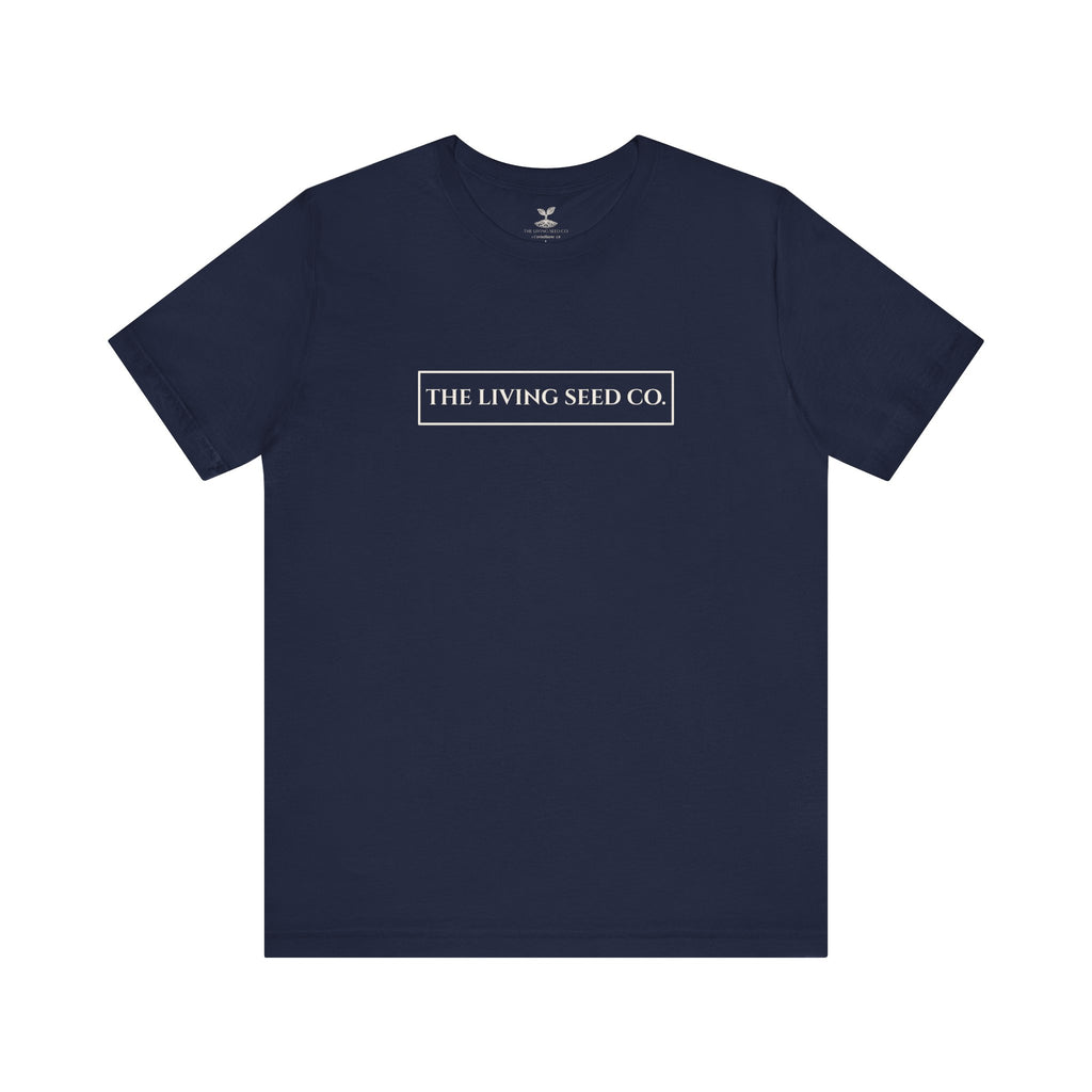 The Original Tee in Navy — front view flat mockup — navy unisex t-shirt featuring The Living Seed Co. boxed wordmark on chest in parchment ink. Bella+Canvas 3001.