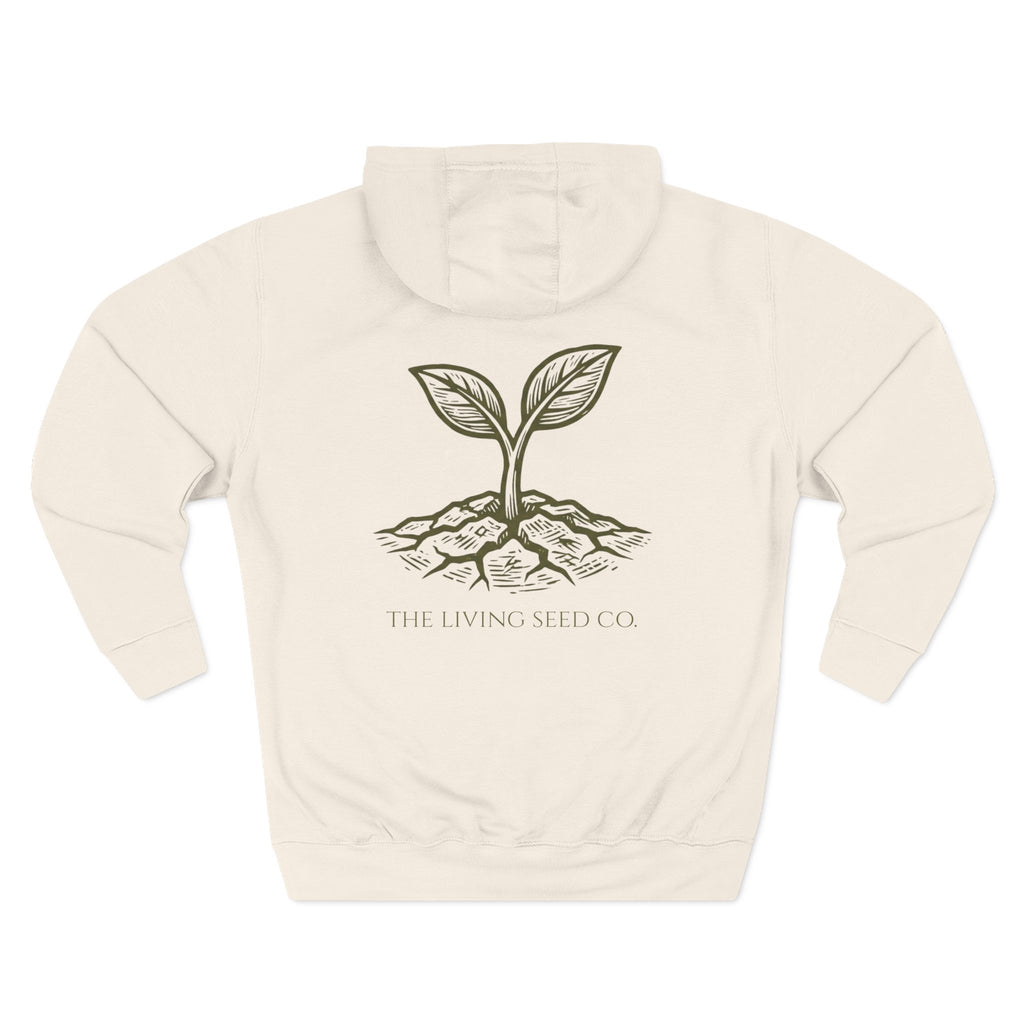 The Original Hoodie (Lane Seven) in Sandshell — back view flat mockup — sandshell pullover hoodie featuring The Living Seed Co. etching-style sprouting seed graphic in olive ink with wordmark below. Lane Seven LS14001.