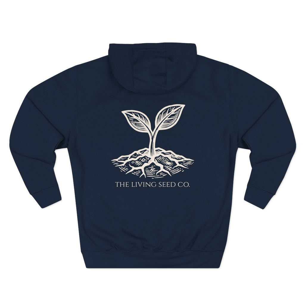 The Original Hoodie (Lane Seven) in Navy — back view flat mockup — navy pullover hoodie featuring The Living Seed Co. etching-style sprouting seed graphic in parchment ink with wordmark below. Lane Seven LS14001.