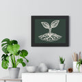 The Original Framed Poster in Black hanging on a gray wall above a shelf with houseplants, featuring an etching-style sprouting seed illustration on a Forest Deep background