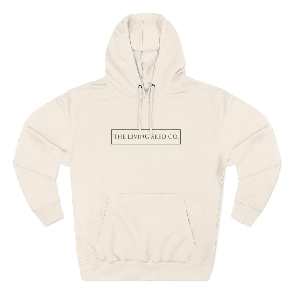 The Original Hoodie (Lane Seven) in Sandshell — front view flat mockup — sandshell pullover hoodie featuring The Living Seed Co. boxed wordmark on chest in olive ink. Lane Seven LS14001.